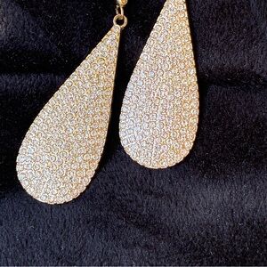 Glamorous gold teardrop drop earrings pavé covered in sparkling clear crystals.